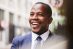 Business, black man and smile in city, success and happy outdoor for startup company, contract and .